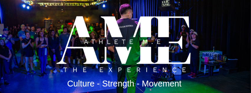 AME crowd with founder JB on stage in front of giant AME logo